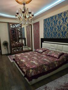 a bedroom with a large bed and a chandelier at Paradise Otel 