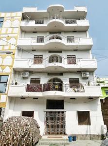 a white building with balconies on it at Shahi House in Bodh Gaya