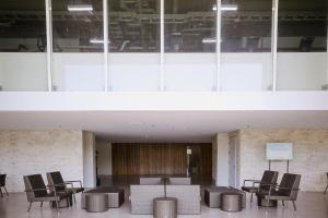 a lobby with chairs and tables in a building at The Studio Haven in Bacolod