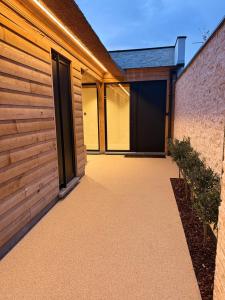 a pivot door of a house with a brick wall at Luxe Guestroom free bikes and parking in Bruges