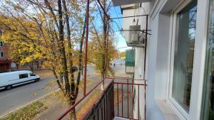 a balcony of a building with a tree on a street at Новая квартира-апартаменты в центре in Izmail