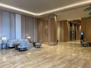 a lobby of a hotel with chairs and tables at Tokyo River side PIK2 By Micky Studio 7 in Muara