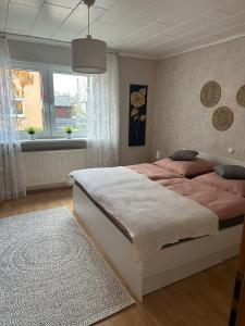 a bedroom with a large bed and a window at Ferienwohnung Riva in Kronau