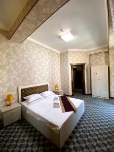 Postel nebo postele na pokoji v ubytování Yulduz Hotel