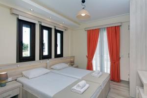 Ένα ή περισσότερα κρεβάτια σε δωμάτιο στο Agnanti Houses