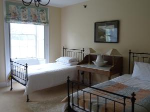 a bedroom with two beds and a window at Baysdale Abbey in Battersby