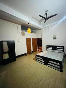 a bedroom with a bed and a ceiling fan at Destiny Home stay in Tezpur +11 photos