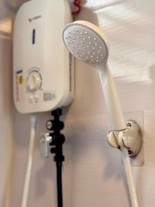 a hair dryer is attached to a wall at LoftVibes San Juan - 4 in San Juan +21 photos