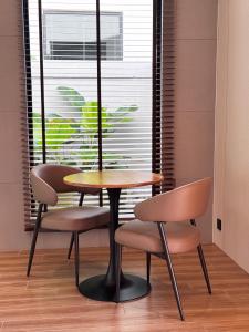 a table and two chairs in a room with a window at Tambuna Retreat ,TAMBUN ,IPOH in Tambun +30 photos