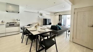 a kitchen and living room with a table and chairs at Grandioso Onna 7-D - Vacation STAY 10524v in Atsutabaru