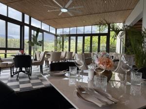 a dining room with a table and chairs and windows at Webersburg in Stellenbosch