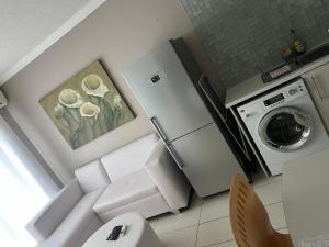 a kitchen with a refrigerator and a washing machine at Villa Kristine 3 in Windhoek