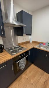 a kitchen with a stove top oven next to a sink at City centre studio in Hull