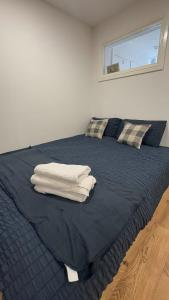 a bedroom with a blue bed with towels on it at City centre studio in Hull