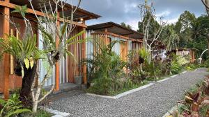a house with a gravel path next to a building at Puris Alam Bali in Tabanan