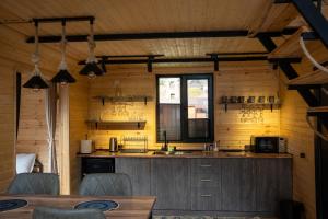 a kitchen with wooden walls and a counter top at Outdoor Cottages Kazbegi in Kazbegi