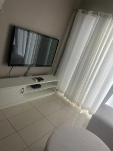 a white room with a tv and a toilet at Villa Kristine 3 in Windhoek