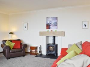 a living room with a fireplace and a couch at Crubisdale in Blairmore
