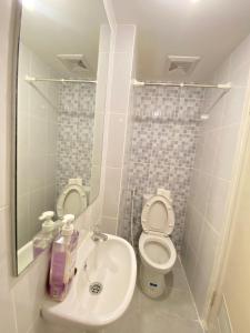 a small bathroom with a toilet and a sink at Tokyo River side PIK2 By Micky Studio 10 in Muara +12 photos