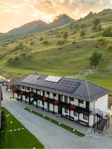 a building with solar panels on top of it at Pensiunea Suci in Botiza