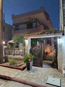 a building with a door with flowers in front of it at Morfeas apartments in Sarti