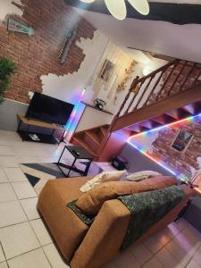 a bedroom with a bed and a staircase with lights at La Phyllade in Monthermé +7 photos