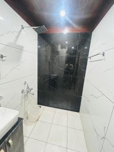 a bathroom with a shower and a sink and a toilet at 3 H Homestay in Mussoorie
