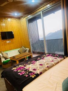 a bedroom with a bed with flowers on it at 3 H Homestay in Mussoorie