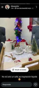 a christmas room with a table with a christmas tree at Hotel en Pedernales in Pedernales