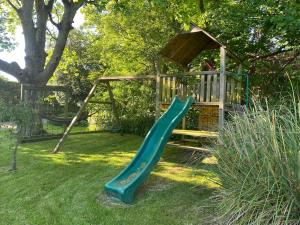 a playground with a slide in the grass at The Barn, Walworth Demesne in Ballykelly +22 photos