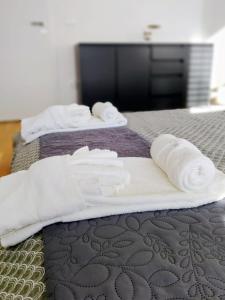 two beds with white towels on top of them at Apartments Ana in Maribor