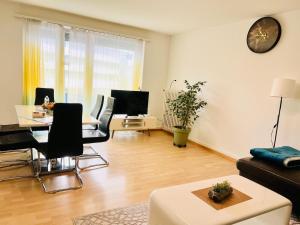 a living room with a couch and a table at Vantage Point 101 in Olten