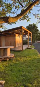 a pavilion with a picnic table in a park at L'Entracte in Saint-Paul-du-Bois