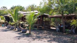 a house with palm trees in front of it at Beachfront Aircon Modern Bahay Kubo for 10 pax in Caba +25 photos