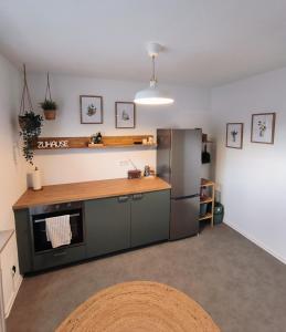 a kitchen with a refrigerator and a counter top at Ferienwohnung Waldgeflüster in Melle