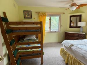a bedroom with two bunk beds and a window at Family Vacation Home - Stunning Views across Salt Pond in Bethany Beach