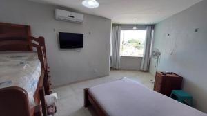 Ένα ή περισσότερα κρεβάτια σε δωμάτιο στο Lindo Apartamento Varandas do Atlântico