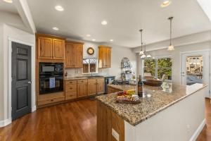 a kitchen with wooden cabinets and a granite counter top at 1144 Equinox in Colorado Springs