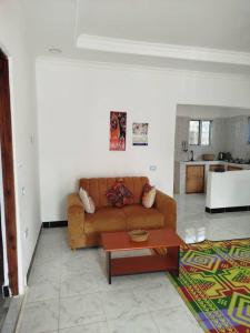 a living room with a couch and a table at Fun Haribo B&B Apartment in Uroa +30 photos