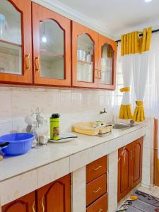 a kitchen with wooden cabinets and a counter top at Naka homes in Lanet +52 photos