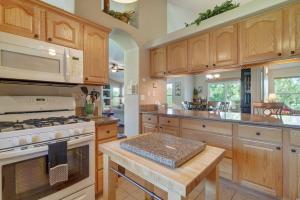 a kitchen with wooden cabinets and a stove top oven at 120 Winding Meadow in Monument