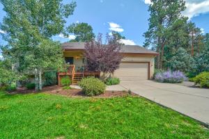 a house with a driveway and a garage at 120 Winding Meadow in Monument