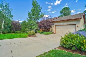 a house with a driveway and a garage at 120 Winding Meadow in Monument
