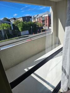 a window with a view of a city street at Chriatcurrch Best Home in Christchurch