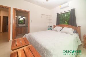 a bedroom with a large bed and a window at Nica Nest 3Br Eco Home Escamequita, NI in San Juan del Sur +27 photos