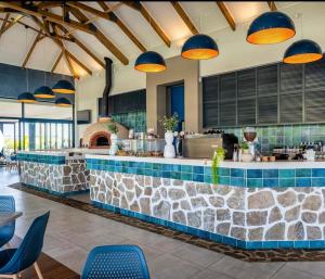 a restaurant with a stone counter and blue chairs at 832 Villa in Ballito