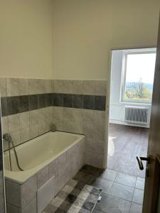 a bath tub in a bathroom with a window at Apartmán 28 in Horní Město +22 photos