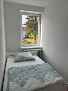 a bedroom with a bed and a window at Apartmán 28 in Horní Město