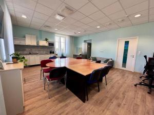a room with a table and chairs and a kitchen at ATB9 Guest House in Valga