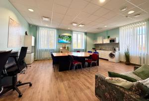 a room with a table and chairs and a kitchen at ATB9 Guest House in Valga